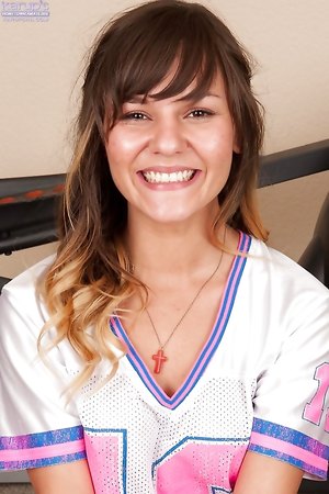 Brunette teen Rio Petite takes off her jersey and bares lovely natural tits