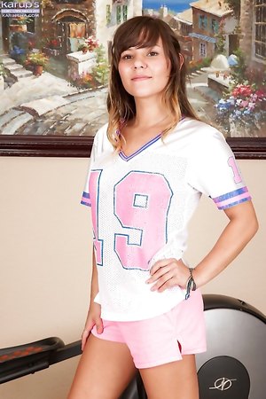 Brunette teen Rio Petite takes off her jersey and bares lovely natural tits