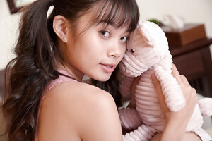 Petite asian teen Sowan posing naked while holding her teddy bear
