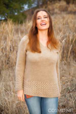 Curvy brunette mature Vassanta flaunts her huge natural assets out in the field