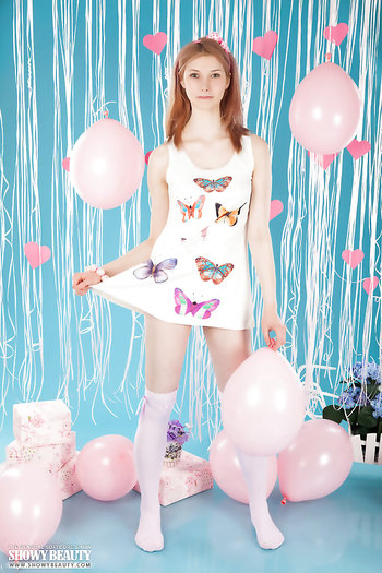 Cute red haired teen Candy Bloom shows off how flexible she is by spreading her legs