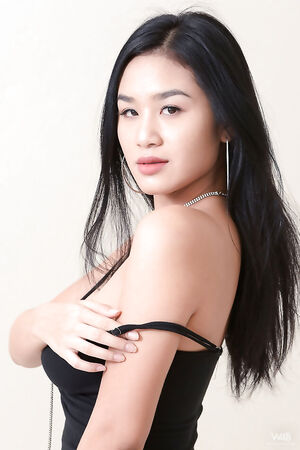 Naturally busty asian babe Kahlisa strips her tight dress to reveal hairy beaver