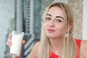 Cute blonde with pigtails Iva drinking milk and flashing big tits