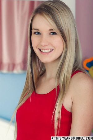 Cute blonde teen Jewel A strips naked in her bedroom and poses for the cam