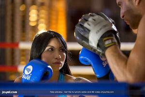 Boxer babe Rina Ellis sits on the instructors thick piece of wood