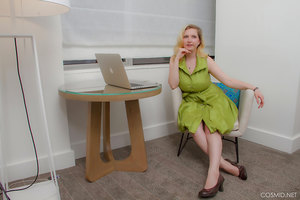 Mim Turner with natural big tits undresses green dress to pose naked on couch