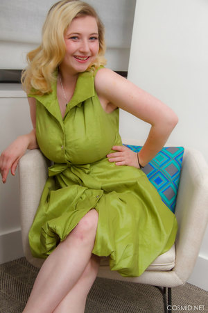 Mim Turner with natural big tits undresses green dress to pose naked on couch