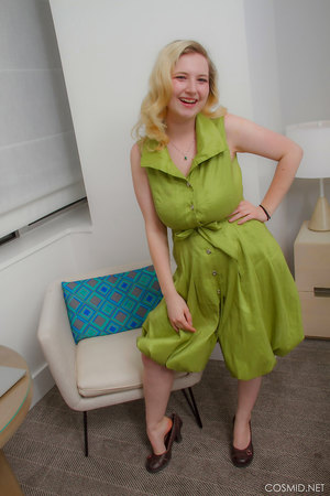 Mim Turner with natural big tits undresses green dress to pose naked on couch