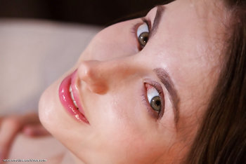 Stunning brunette Logan spreads her legs to show off her shaved vulva