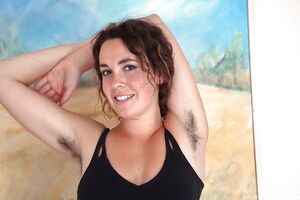 Hairy girl Lola Wilde strips and spreads her legs and pussy lips wide
